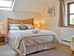 a bedroom with a bed and a window at Llanlliwe Cottage in Henllan Amgoed