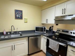 a kitchen with a sink and a stove top oven at Livable B in kirkland in Kirkland