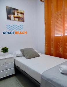 two beds in a room with a sign on the wall at APARTBEACH SALOU y PLAYA 742 in Salou