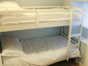 two bunk beds in a room with a bed at Nutmeg Cottage in Tideswell