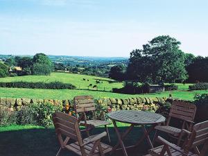 a table and chairs with a view of a field at Spring Cottage-e3846 in Kirk Ireton