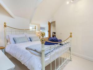 een slaapkamer met een wit bed in een kamer bij Curlews in Newlyn
