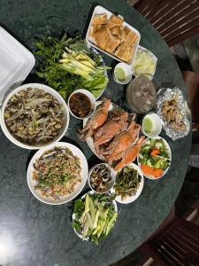 a table with many plates of food on it at Hotel Minh Vy in Long Hai