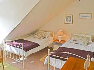 a bedroom with two beds in a attic at Wherry Cottage in Wells next the Sea
