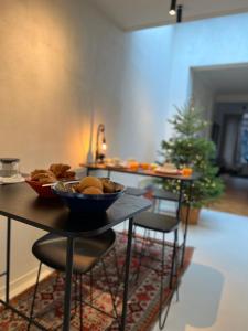 a table with bowls of food on it with a christmas tree at Maison Georges in Turnhout