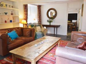 a living room with couches and a wooden coffee table at The Old Mill in Bucks Mills