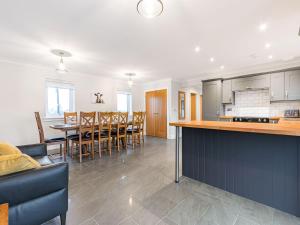 a kitchen and dining room with a table and chairs at Gartclach-uk40001 in Gartmore