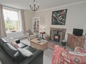 a living room with a couch and a fireplace at West View Cottage - E5386 in Two Dales