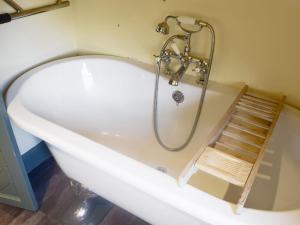 a bath tub with a ladder in a bathroom at But n Ben in Lochdon