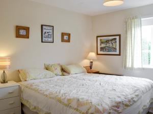 a bedroom with a bed and a window at The Old Granary in Newent