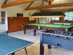 two ping pong tables in a room with billards at Meadow View - Ijv in Brigham