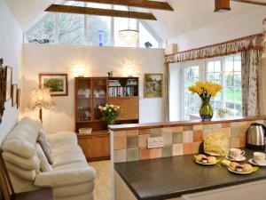 a living room with a couch and a table at Stowford Linhay - E3138 in Lewdown