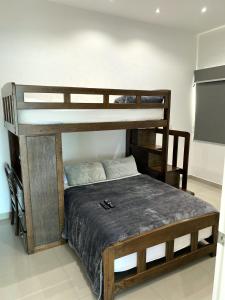 a bedroom with two bunk beds in a room at Torre EME Department in Mazatlán