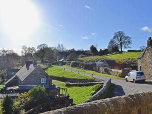 a house on a hill next to a road at Old School House in Kirk Ireton