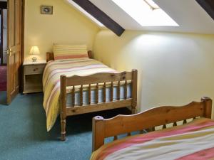 a bedroom with two beds and a skylight at Craneham Court in Buckland Brewer
