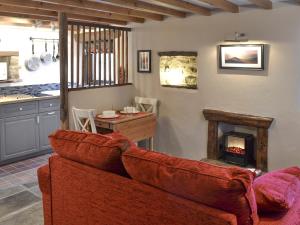 a living room with a couch and a fireplace at The Old Stable in Edale