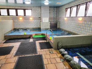 a large pool of water in a large room with at First Inn Takamatsu in Takamatsu