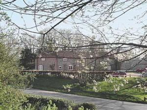 a large house with a car parked in front of it at Cobble Stones in Holt