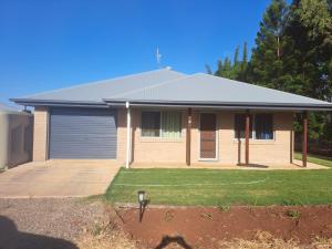 a brick house with a garage at Markwell St Villas in Kingaroy