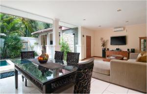 a living room with a table and a couch at 6BR Villa Sensel - Minggu Villas Seminyak in Seminyak
