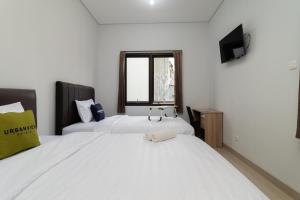 Postel nebo postele na pokoji v ubytování Urbanview Hotel Pasar Baru Jakarta by RedDoorz