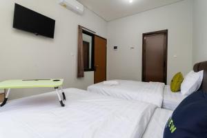 Postel nebo postele na pokoji v ubytování Urbanview Hotel Pasar Baru Jakarta by RedDoorz