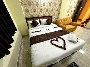 a bedroom with a bed with a heart made up at Hotel East park Electronic City in Bangalore