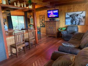 a living room with a couch and a bar in a house at Lake Lodge in Goughs Bay