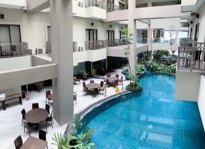 an image of a hotel lobby with a swimming pool at Savana Hotel & Convention Malang in Malang