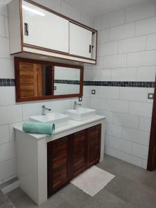 a bathroom with two sinks and a mirror at Beautiful House with private pool in Mauritius in Albion
