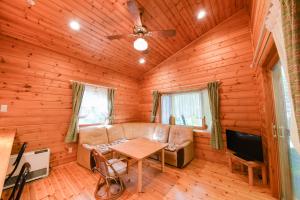 a living room with a couch and a table at Shurin in Tsumagoi