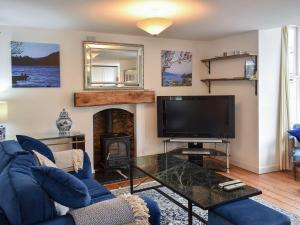 a living room with a tv and a fireplace at Station House in Staveley