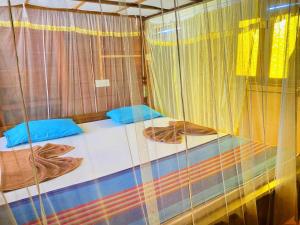 Postel nebo postele na pokoji v ubytování Little Pumpkin Cabanas