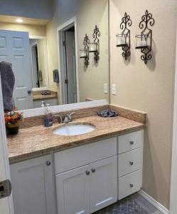 a bathroom with a sink and a large mirror at Livable D near Lake Washington in Lake Forest Park