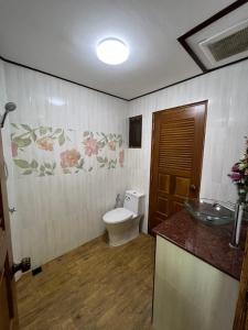 a bathroom with a toilet and a sink at บ้านทรายแก้ว 129HOUSE in Klaeng