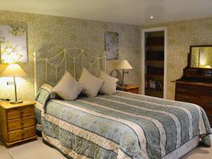 a bedroom with a large bed in a room at Gardeners Bothy in Balnaboth