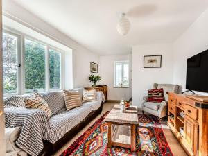 a living room with a couch and a tv at 4 Cromwells Cottage-uk40933 in Pembroke