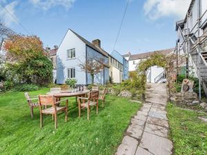 a table and chairs in the yard of a house at 4 Cromwells Cottage-uk40933 in Pembroke