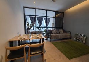 a living room with a table and a couch at Bangsar Trade Centre Kuala Lumpur by SkyLimit Suites in Kuala Lumpur