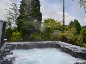 a hot tub with water in a backyard at Glebe Farm Bungalow in Market Rasen