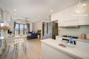 a kitchen and living room with a table and chairs at Kim Ngan Phat Deluxe Apartment in Danang