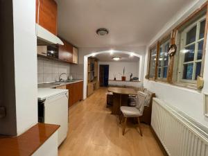 a kitchen with a sink and a table in it at Ada-Ini House in Craiova