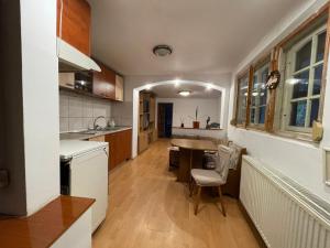 a kitchen with a sink and a table in it at Ada-Ini House in Craiova +5 photos