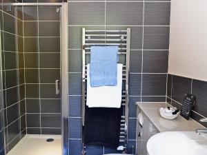 a bathroom with a towel rack and a shower at Cairn View in Strachan