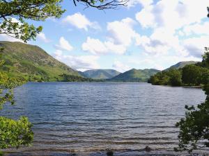 a view of a lake with mountains in the background at Berrymoor Farm Cott in Kirkoswald