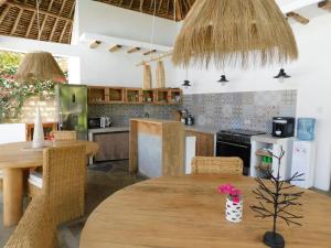 a kitchen with a wooden table and a dining room at Dama Villa in Watamu
