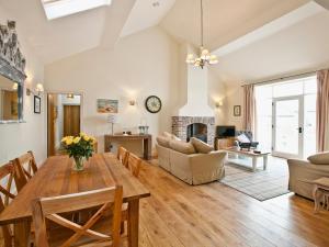 a living room with a table and chairs and a fireplace at Tweedmouth Cottage in Scarborough