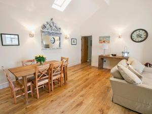 a living room with a table and a couch at Tweedmouth Cottage in Scarborough