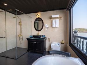 a bathroom with a tub and a sink and a shower at Rita Cruise in Ha Long