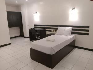 Vuode tai vuoteita majoituspaikassa Hotel Benjamin Naval